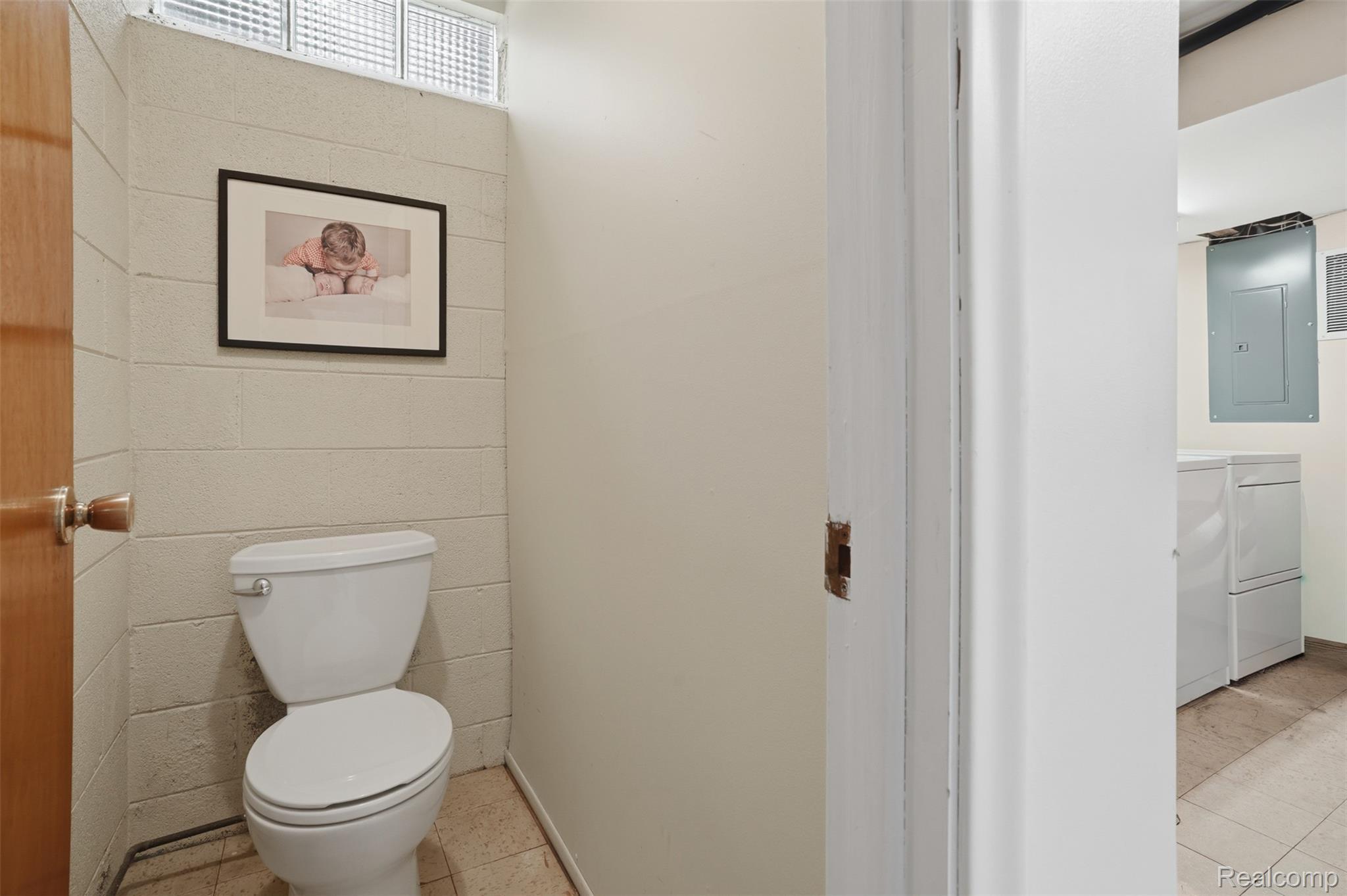 47129 Dunsany Road Northville, MI 48167 - Photo 31 of 49 Bathroom with electric panel, light tile patterned floors, washer and clothes dryer, and vanity