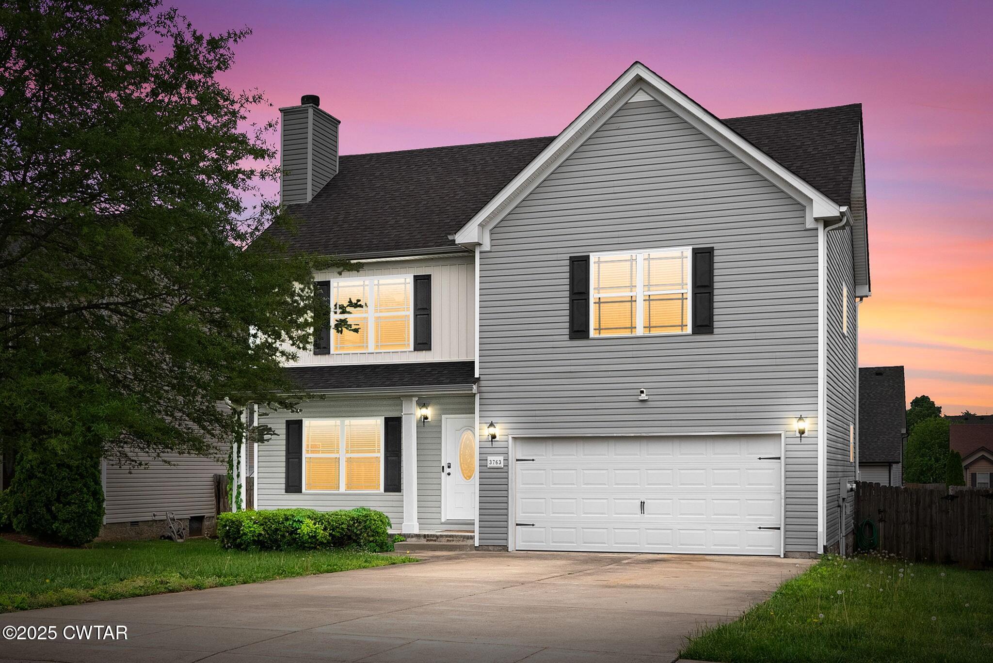 3763 Suiter Road Clarksville, TN 37040 - Photo 1 of 1 a front view of a house with a yard and garage