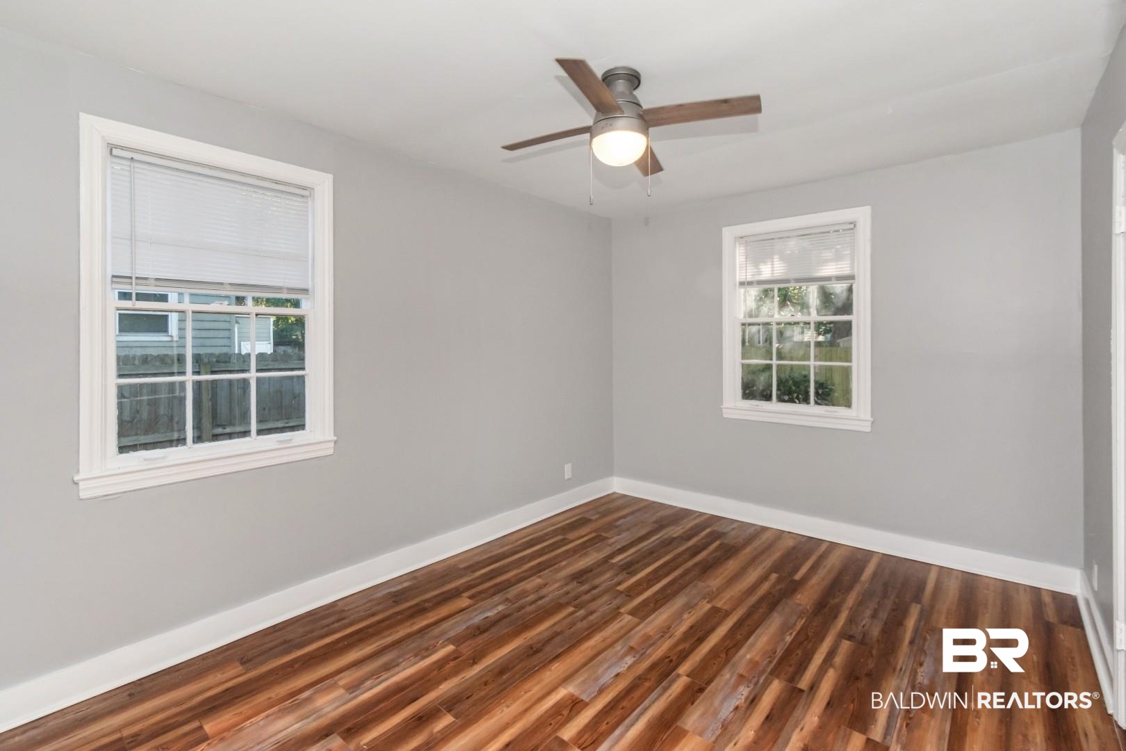 263 Border Drive East Mobile, AL 36608 - Photo 14 of 27 Interior room featuring wood-finish flooring, light gray wall paint, and white trim