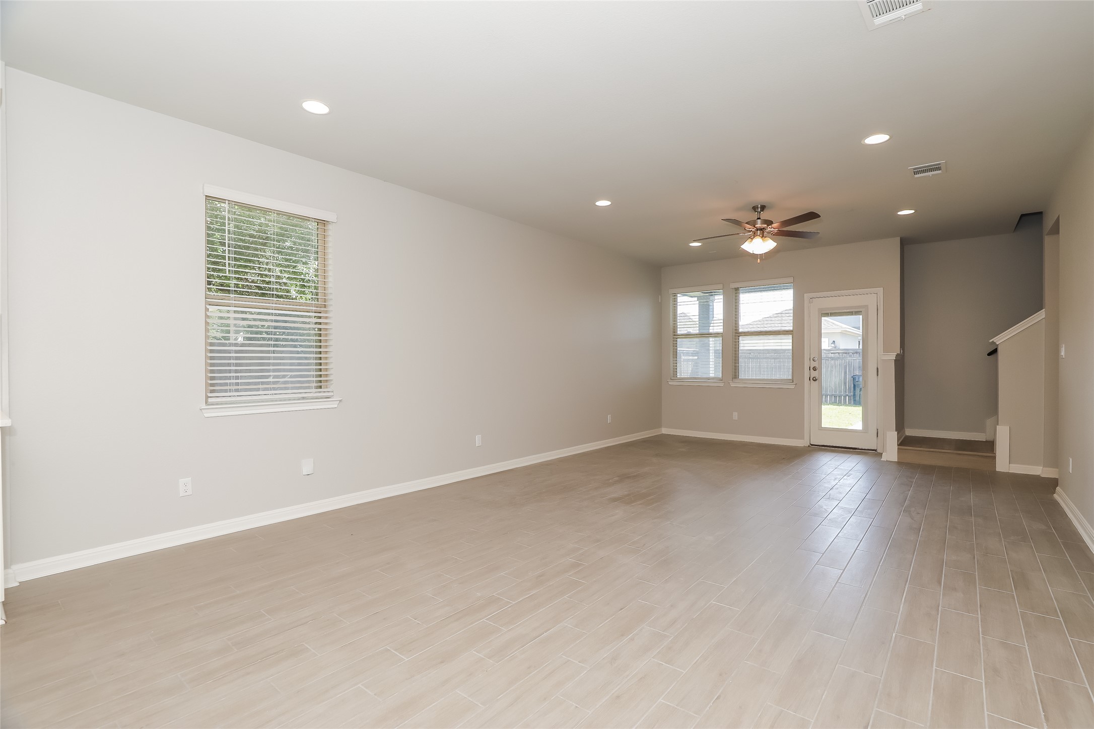 2724 Juniper Woods Road Leander, TX 78641 - Photo 7 of 21 A spacious, open-concept area featuring light-toned flooring and abundant natural illumination from multiple windows.