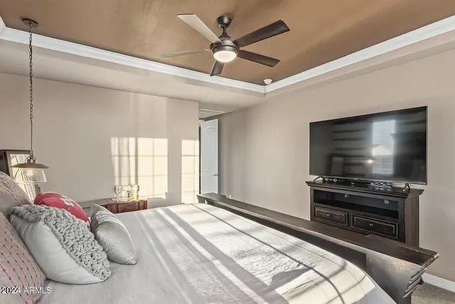 a bedroom with a bed and a flat screen tv