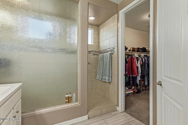 a view of walk in closet with clothes