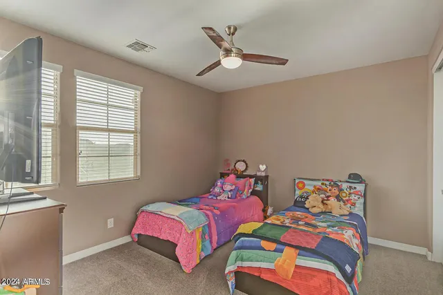 a bedroom with two beds and a window