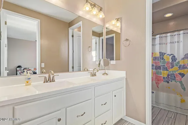 a bathroom with a double vanity sink mirror and double