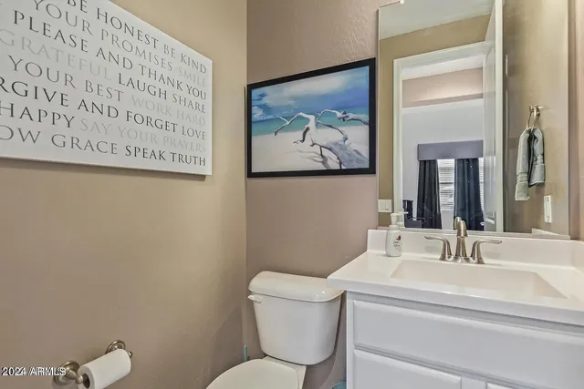 a bathroom with a toilet a sink and a mirror