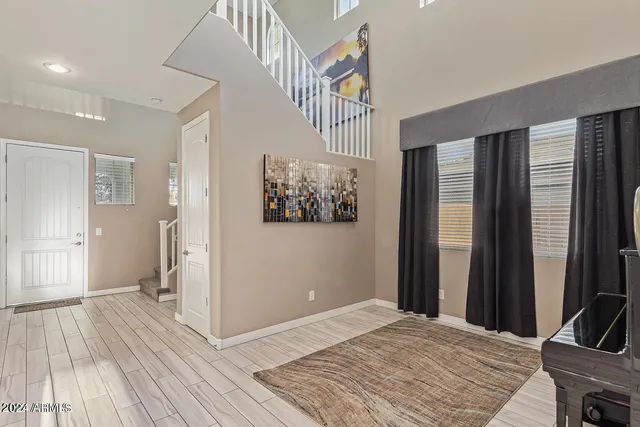 a view of a hallway with wooden floor and staircase