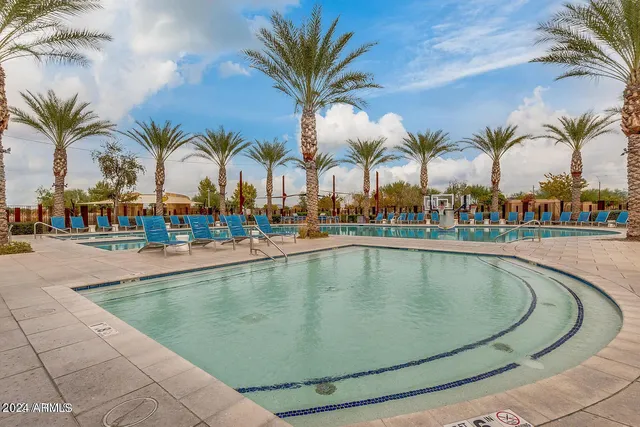 a view of swimming pool with outdoor seating and outdoor seating