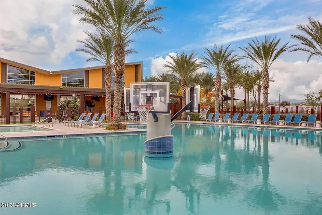 a view of swimming pool of water with palm trees