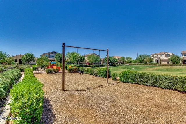 a view of a park with swings and slides