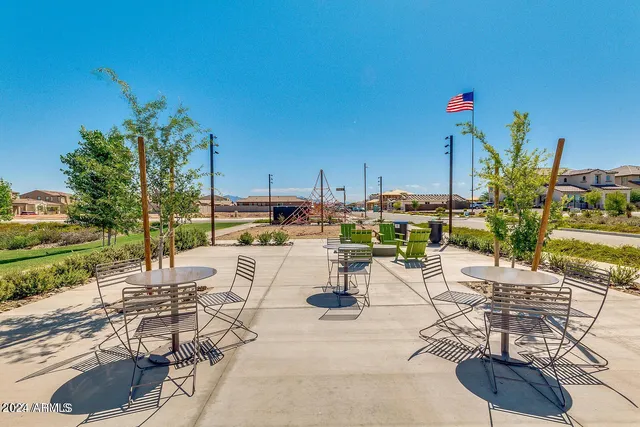 a view of a backyard with plants and chairs