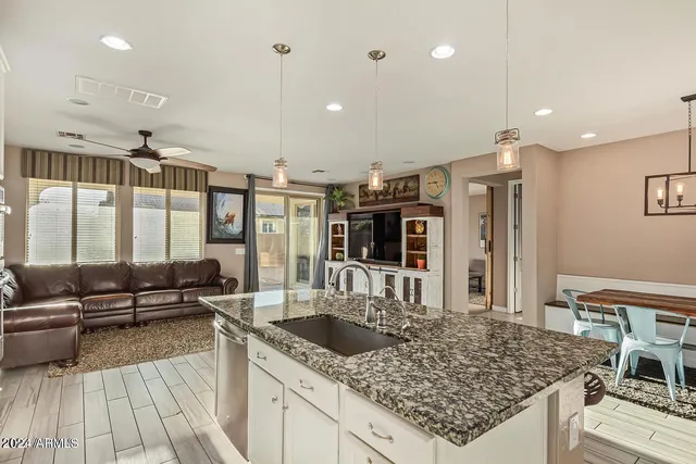 a kitchen with kitchen island granite countertop a sink and counter space