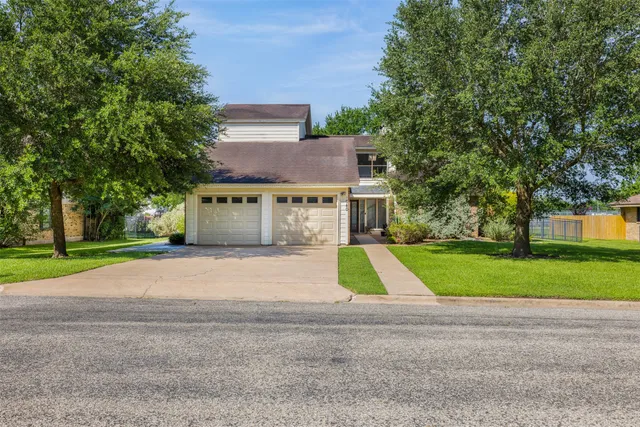 a view of a house with a yard and garage