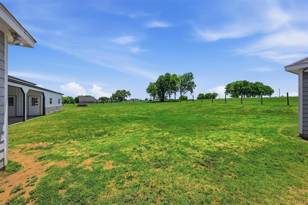 662 Preakness Place Road Van Alstyne, TX 75495 - Photo 27 of 39 a view of a garden with a building in the background