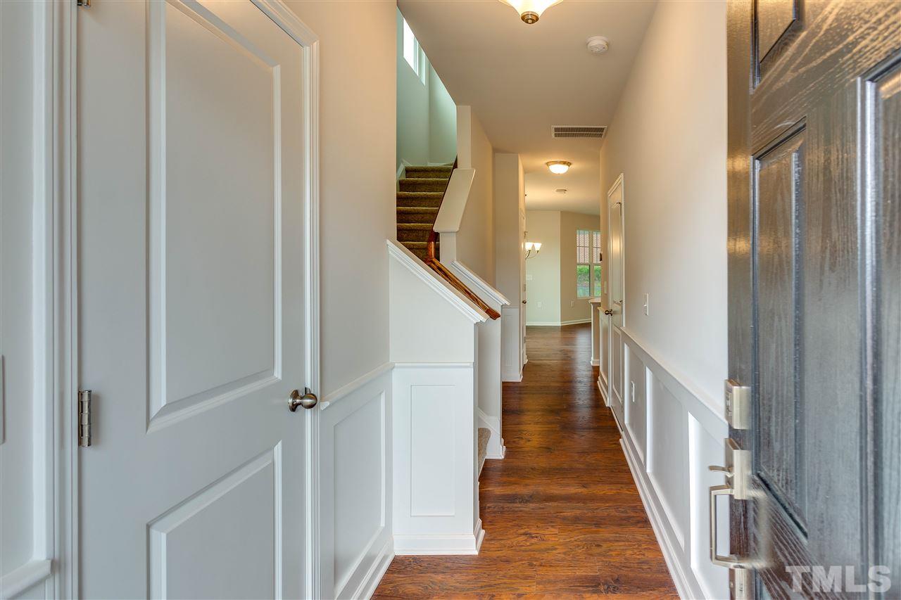 6033 Beale Loop, Unit 14 Raleigh, NC 27616 - Photo 2 of 18 Laminate flooring and Wainscot trim in foyer.