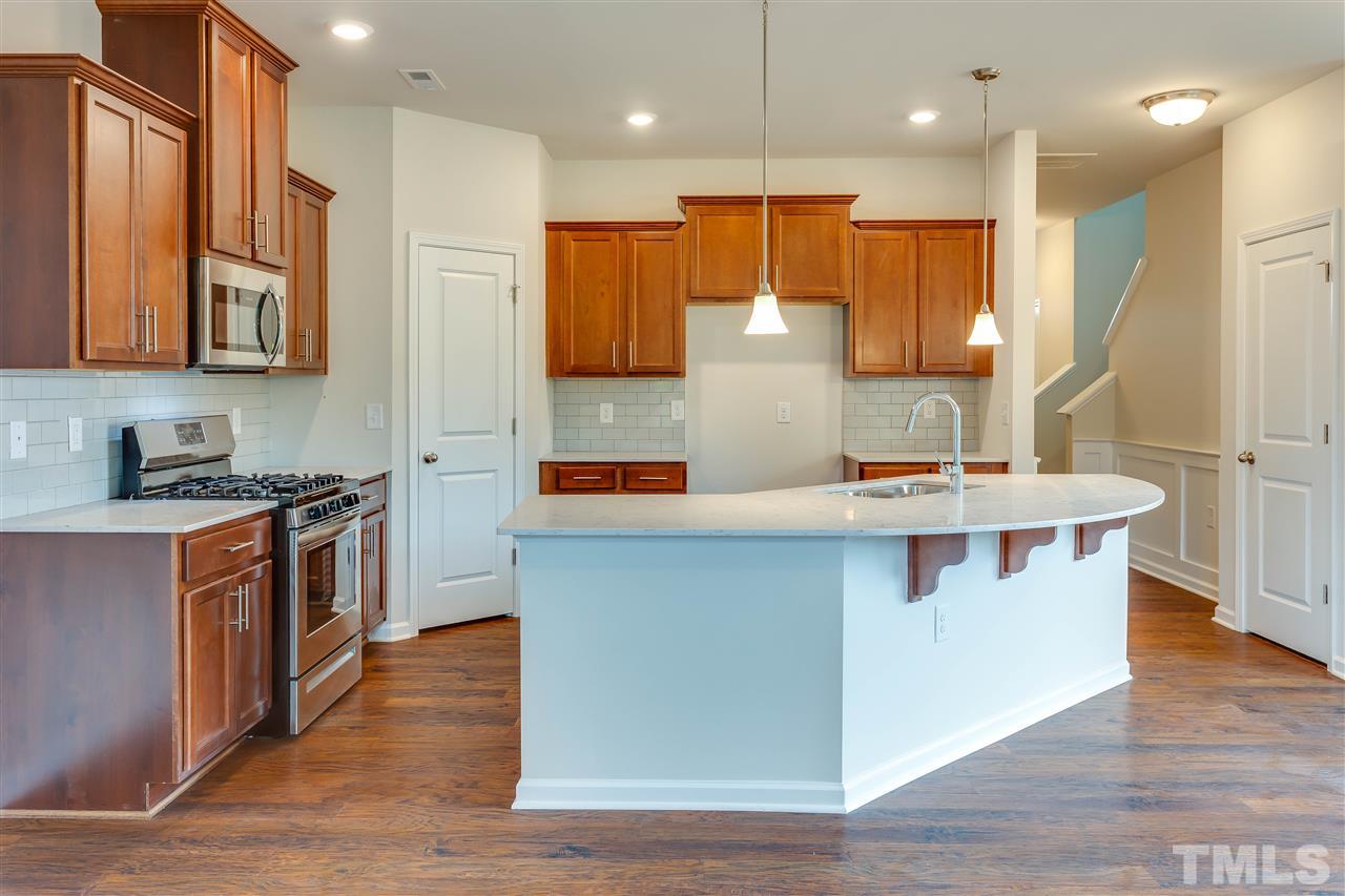 6033 Beale Loop, Unit 14 Raleigh, NC 27616 - Photo 3 of 18 corner pantry and breakfast bar