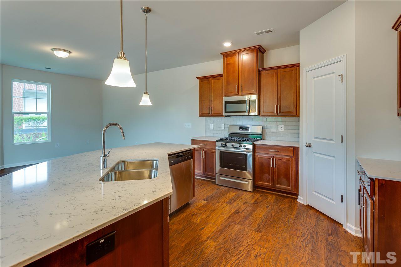 6033 Beale Loop, Unit 14 Raleigh, NC 27616 - Photo 4 of 18 Pendant lighting and stainless appliances.