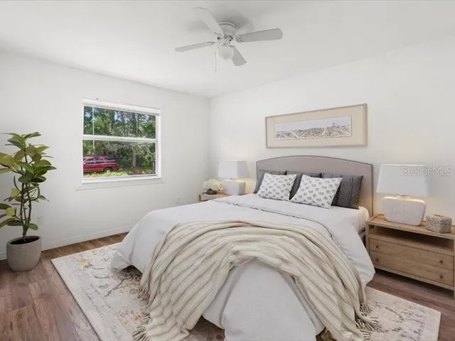 a bedroom with a bed and a potted plant