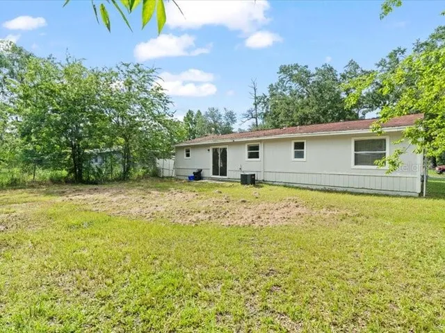 a view of a house with a backyard