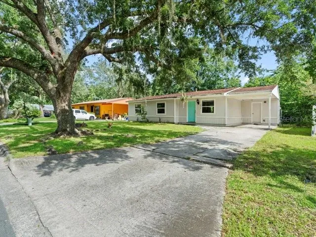 a front view of house with yard and green space