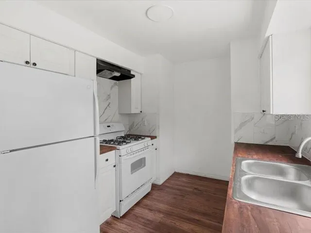 a kitchen with a stove and a refrigerator