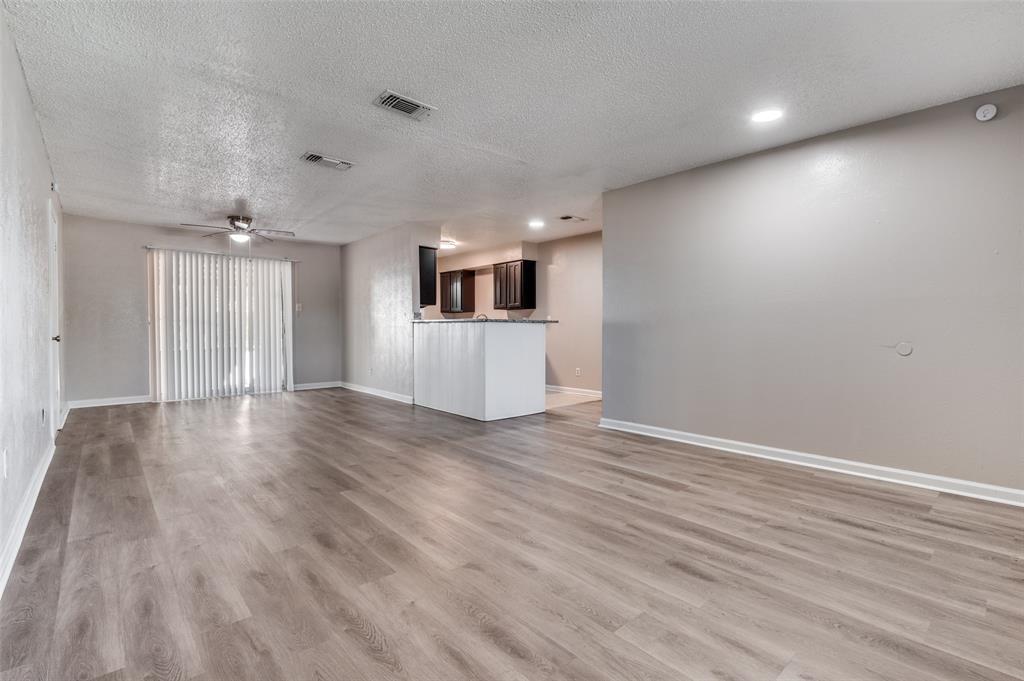 735 Middale Road Duncanville, TX 75116 - Photo 12 of 25 a view of a livingroom with wooden floor and window