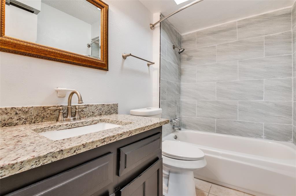 735 Middale Road Duncanville, TX 75116 - Photo 19 of 25 a bathroom with a granite countertop sink toilet and shower