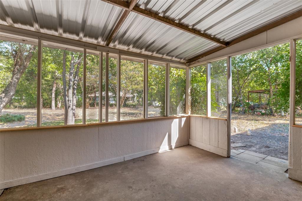 735 Middale Road Duncanville, TX 75116 - Photo 21 of 25 a view of an empty room with a fireplace and a large window