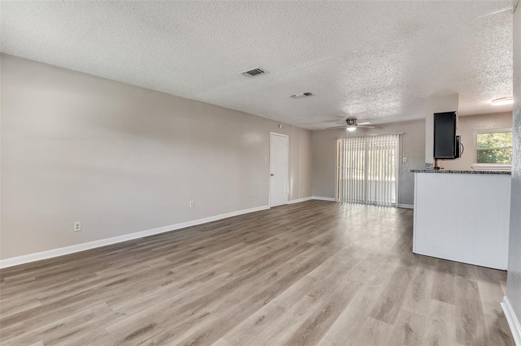 735 Middale Road Duncanville, TX 75116 - Photo 3 of 25 wooden floor in an empty room with a kitchen