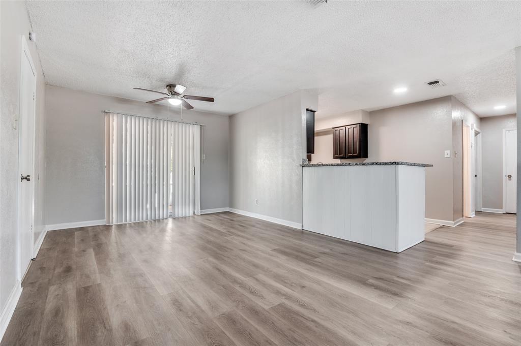 735 Middale Road Duncanville, TX 75116 - Photo 4 of 25 a view of a kitchen with a sink a ceiling fan and wooden floor