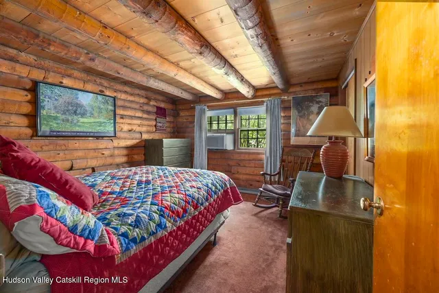 a bedroom with furniture and a window