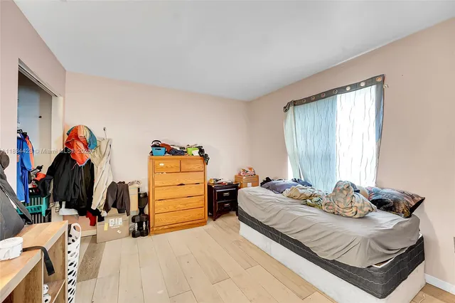 a bedroom with a bed and a closet