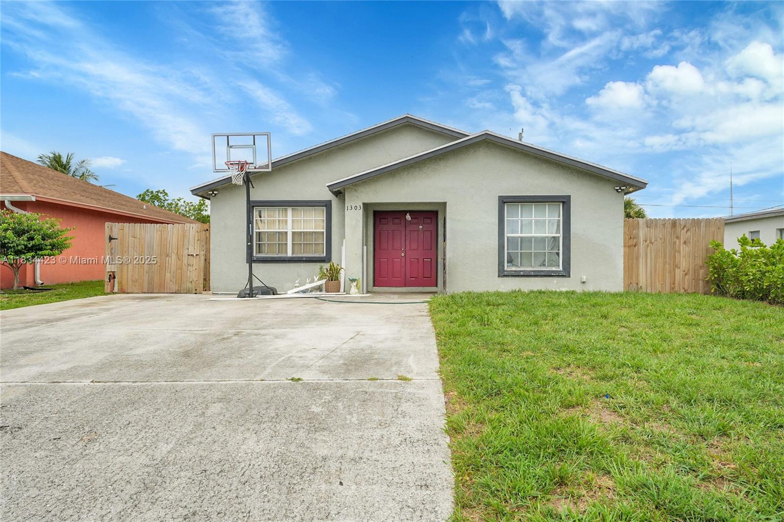 1303 West 6th Street Riviera Beach, FL 33404 - Photo 2 of 33 a view of a house with yard and garage