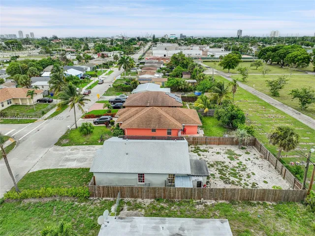 an aerial view of a house with outdoor space and street view
