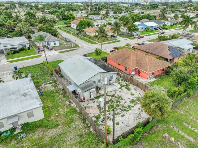 an aerial view of residential houses with outdoor space and street view