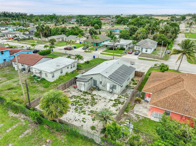 an aerial view of a house with garden space and street view