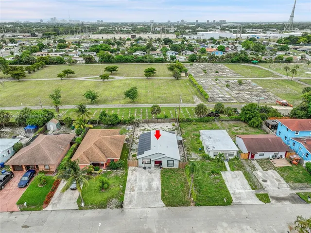 an aerial view of residential houses with outdoor space and lake view
