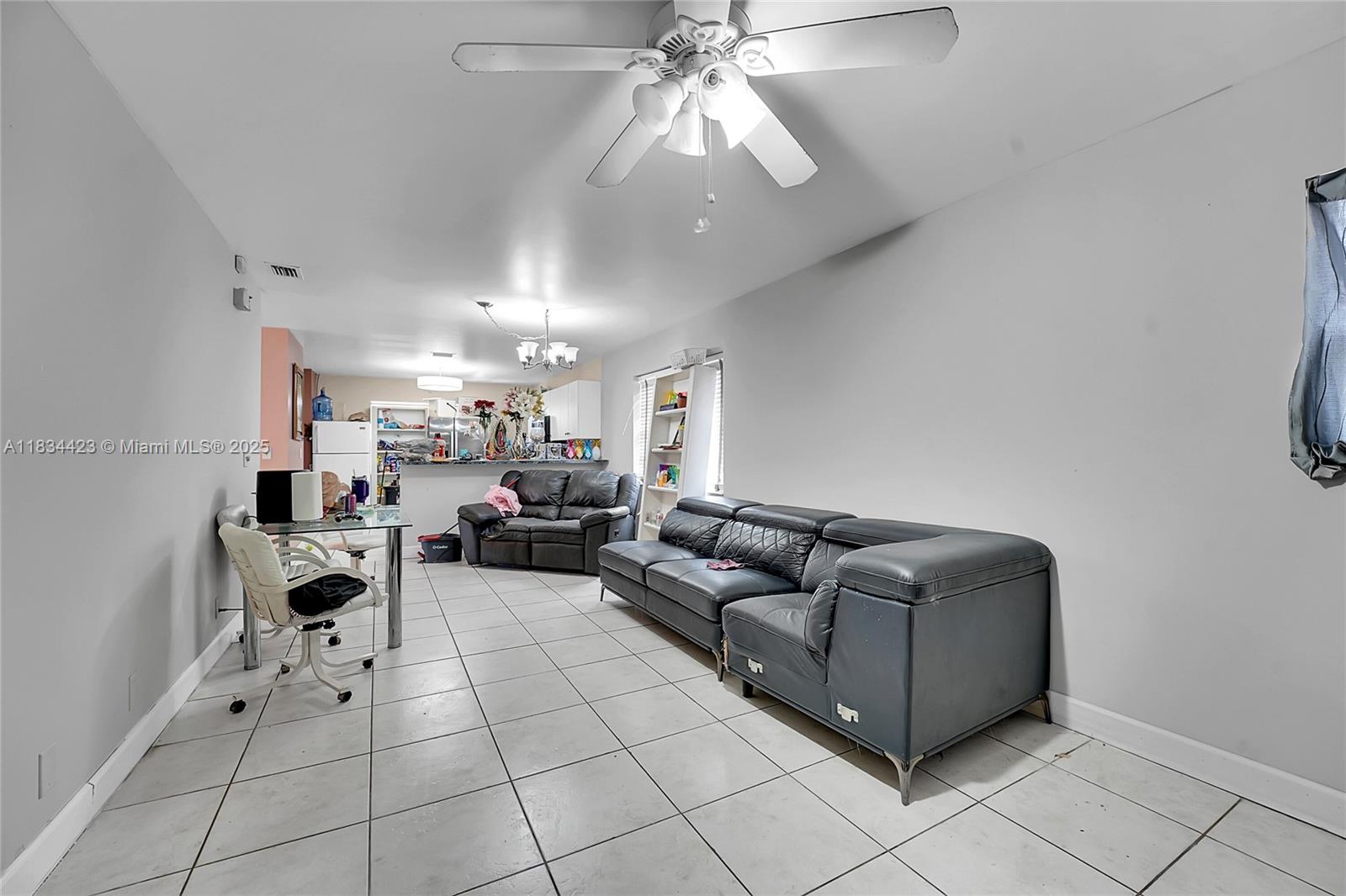 1303 West 6th Street Riviera Beach, FL 33404 - Photo 4 of 33 a living room with furniture and a chandelier