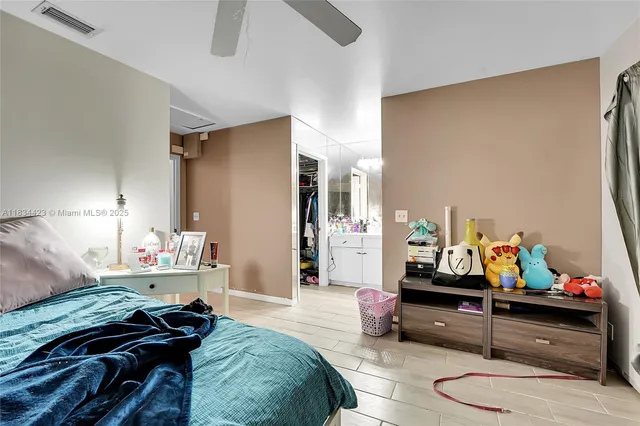 a bedroom with bed and a couch