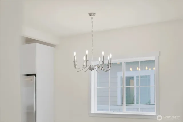 a view of an empty room with a kitchen