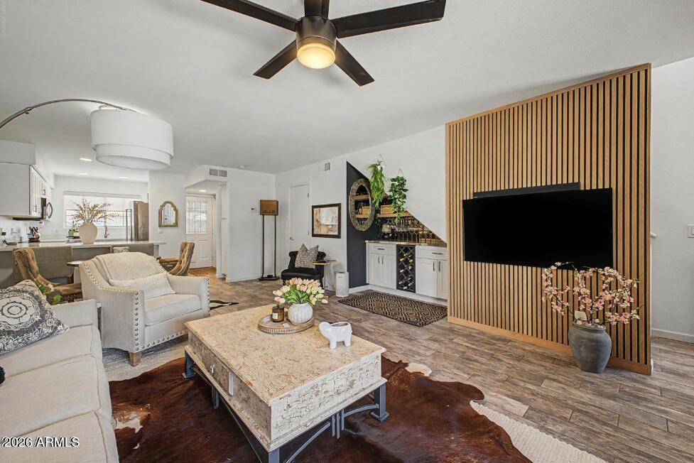 860 North McQueen Road, Unit 1135 Chandler, AZ 85225 - Photo 2 of 24 a living room with furniture a flat screen tv and a fireplace