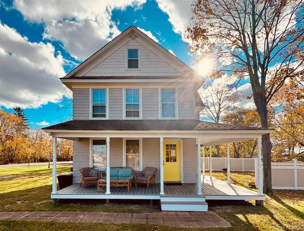 a front view of a house with a yard table and chairs