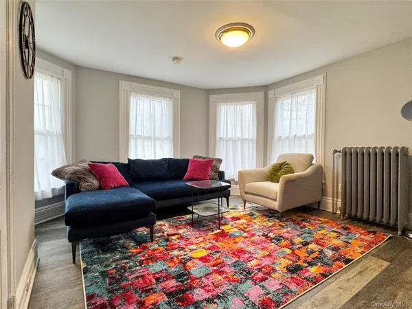 a living room with furniture and a rug