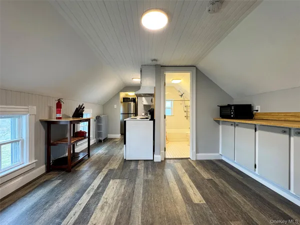 a view of a kitchen with furniture and empty room
