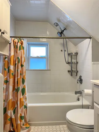 a bathroom with a toilet bathtub and shower