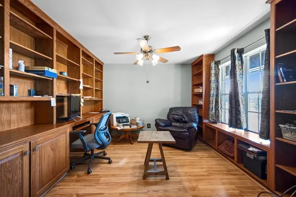 a living room with furniture cabinets and a flat screen tv