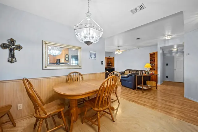 a view of a dining room with furniture and chandelier