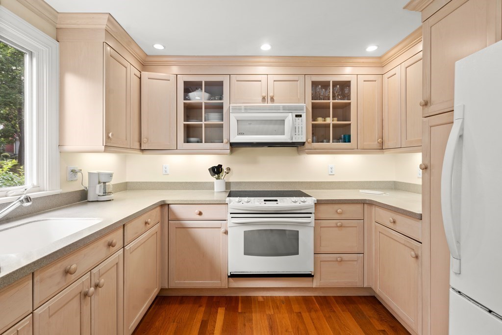 12 Jericho Road, Unit 12 Weston, MA 02493 - Photo 5 of 14 a kitchen with stainless steel appliances granite countertop a sink and cabinets with wooden floor
