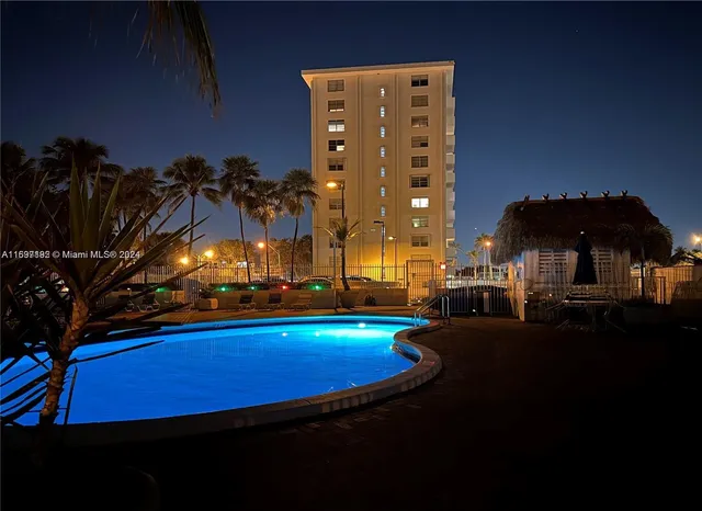 a view of a house with a swimming pool and porch