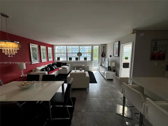 a living room with furniture rug and a large window