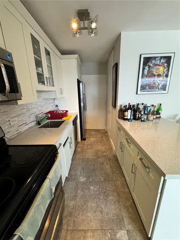 a bathroom with a sink a mirror and a shower